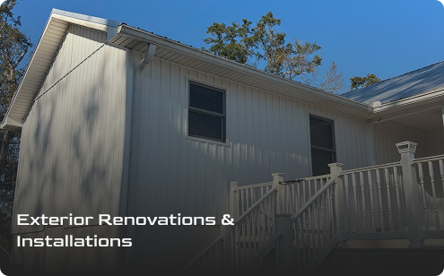 A light-colored house with new siding and windows, featuring a modern railing on the front porch. Text overlay reads: Exterior Renovations & Installations by Prime Roofing and Restoration. Trees are visible in the background.